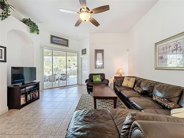 107 Amaca Ln, Davenport, FL 33897 - living room featuring a ceiling fan, light tile patterned floors, and arched walkways