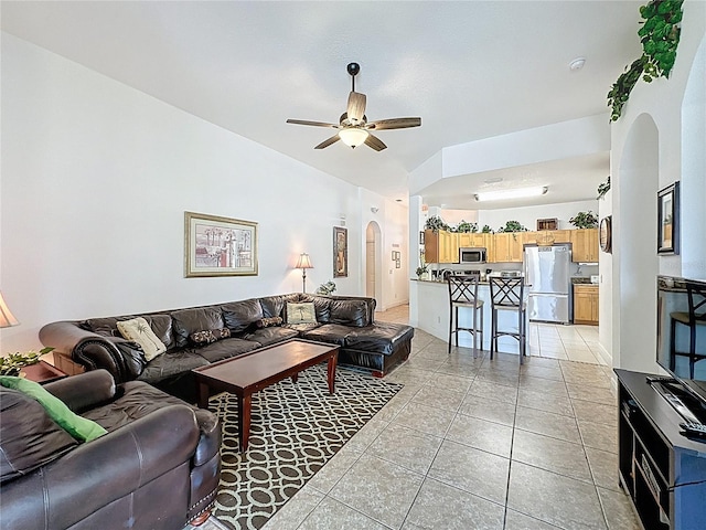 107 Amaca Ln, Davenport, FL 33897 - living area featuring arched walkways, ceiling fan, light tile patterned floors, and lofted ceiling