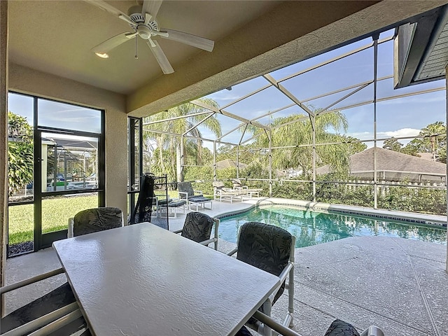 107 Amaca Ln, Davenport, FL 33897 - swimming pool featuring a patio area, ceiling fan, glass enclosure, and outdoor dining space
