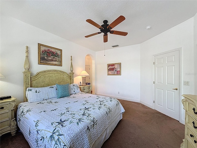 107 Amaca Ln, Davenport, FL 33897 - bedroom featuring dark carpet, arched walkways, and ceiling fan