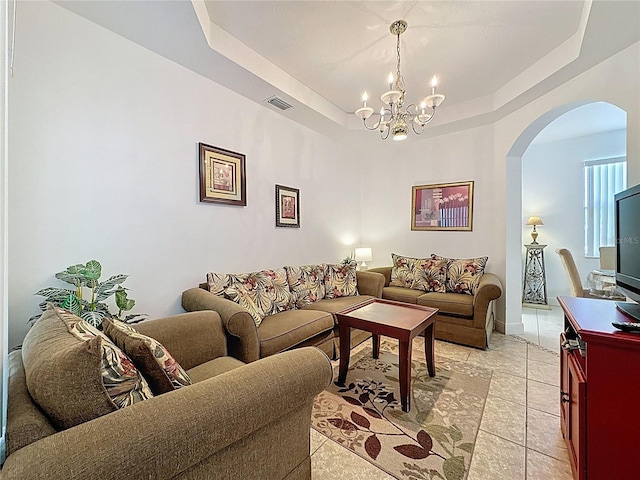 107 Amaca Ln, Davenport, FL 33897 - living area with arched walkways, a chandelier, and a raised ceiling