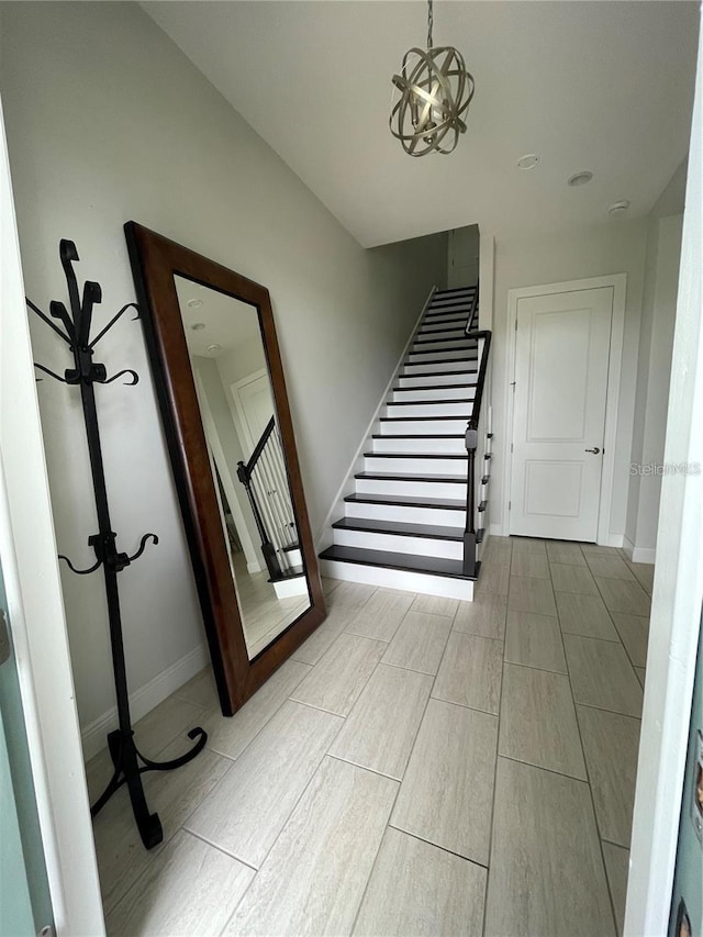 8919 Lakeshore Pointe Dr, Winter Garden, FL 34787 - stairway with wood finished floors and a chandelier
