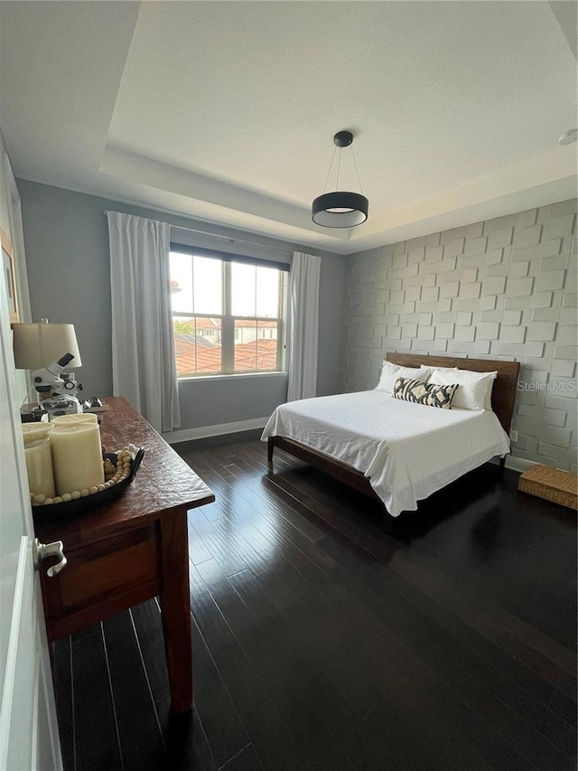 8919 Lakeshore Pointe Dr, Winter Garden, FL 34787 - bedroom with a tray ceiling and dark wood-style floors
