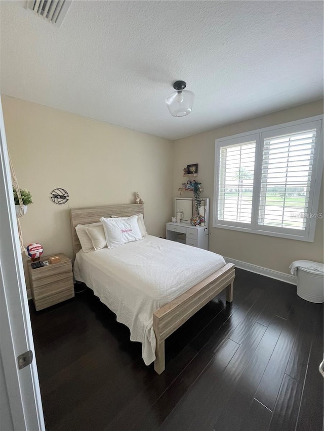 8919 Lakeshore Pointe Dr, Winter Garden, FL 34787 - bedroom featuring dark wood finished floors and a textured ceiling