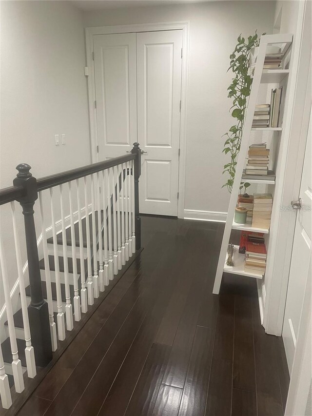 8919 Lakeshore Pointe Dr, Winter Garden, FL 34787 - corridor featuring dark wood-style floors and an upstairs landing