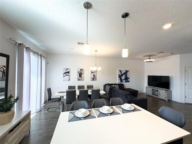 4736 Tribute Trl, Kissimmee, FL 34746 - dining area featuring a textured ceiling, dark wood-style flooring, a chandelier, and recessed lighting