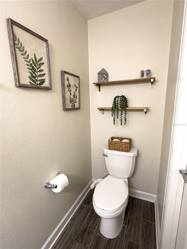 4736 Tribute Trl, Kissimmee, FL 34746 - bathroom with toilet, baseboards, and wood finish floors