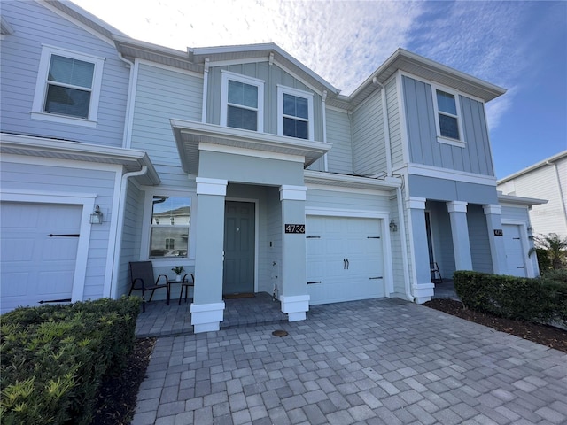 4736 Tribute Trl, Kissimmee, FL 34746 - multi unit property featuring board and batten siding, an attached garage, and driveway