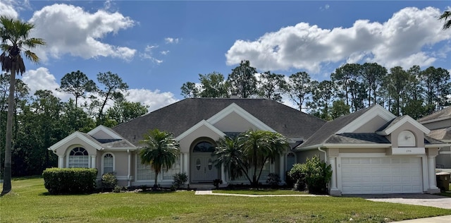2356 Chadwick Cir, Kissimmee, FL 34746 - single story home featuring a front yard, a garage, stucco siding, driveway, and roof with shingles