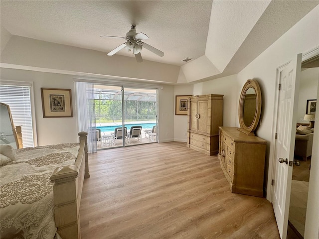 2356 Chadwick Cir, Kissimmee, FL 34746 - bedroom featuring access to exterior, light wood-type flooring, a textured ceiling, a ceiling fan, and baseboards