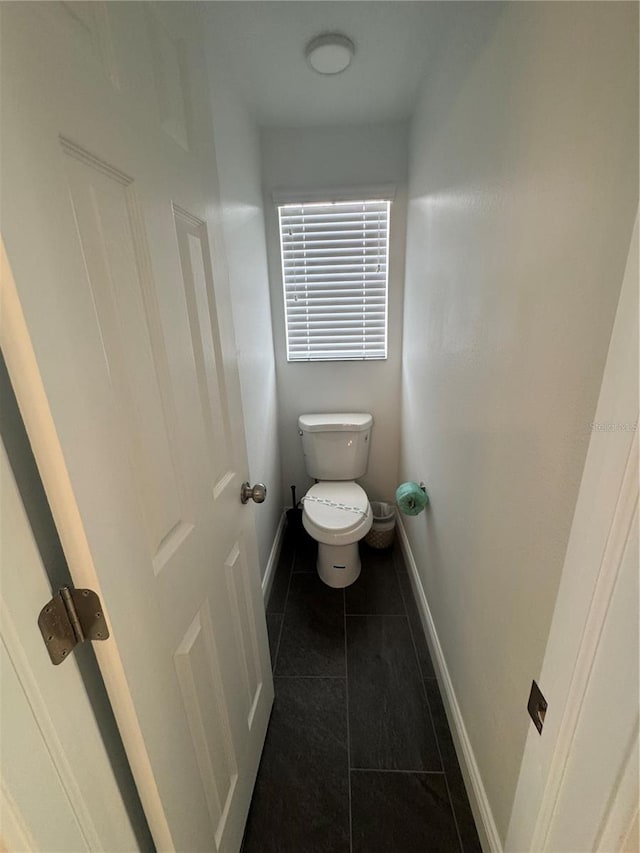 2356 Chadwick Cir, Kissimmee, FL 34746 - bathroom with baseboards, tile patterned flooring, and toilet
