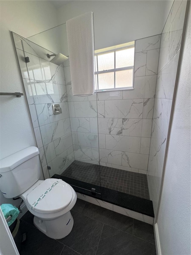 2356 Chadwick Cir, Kissimmee, FL 34746 - bathroom with toilet, tile patterned flooring, and a tile shower