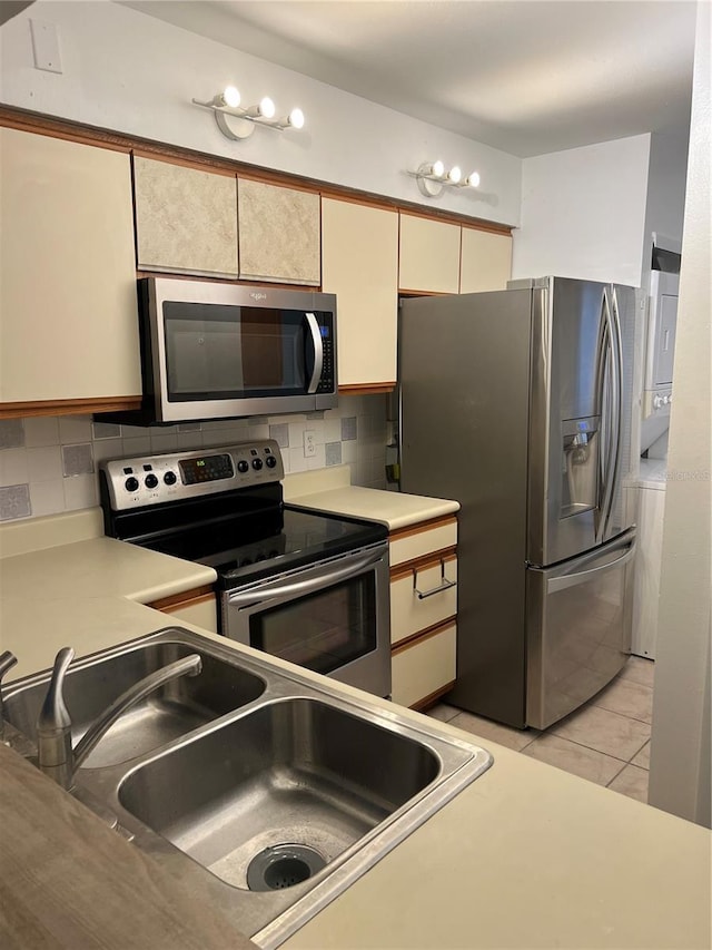 2900 S Semoran Blvd Unit 1, Orlando, FL 32822 - kitchen featuring appliances with stainless steel finishes, a sink, light countertops, and cream cabinets