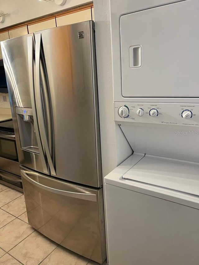 2900 S Semoran Blvd Unit 1, Orlando, FL 32822 - washroom with stacked washer / dryer and light tile patterned floors