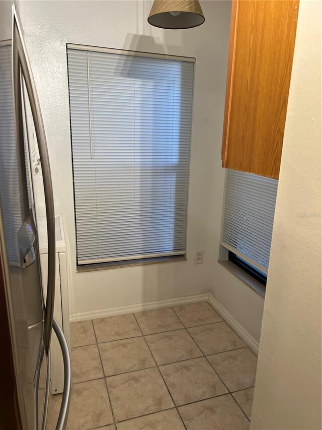 2900 S Semoran Blvd Unit 1, Orlando, FL 32822 - unfurnished dining area with light tile patterned flooring, baseboards, and washer / dryer