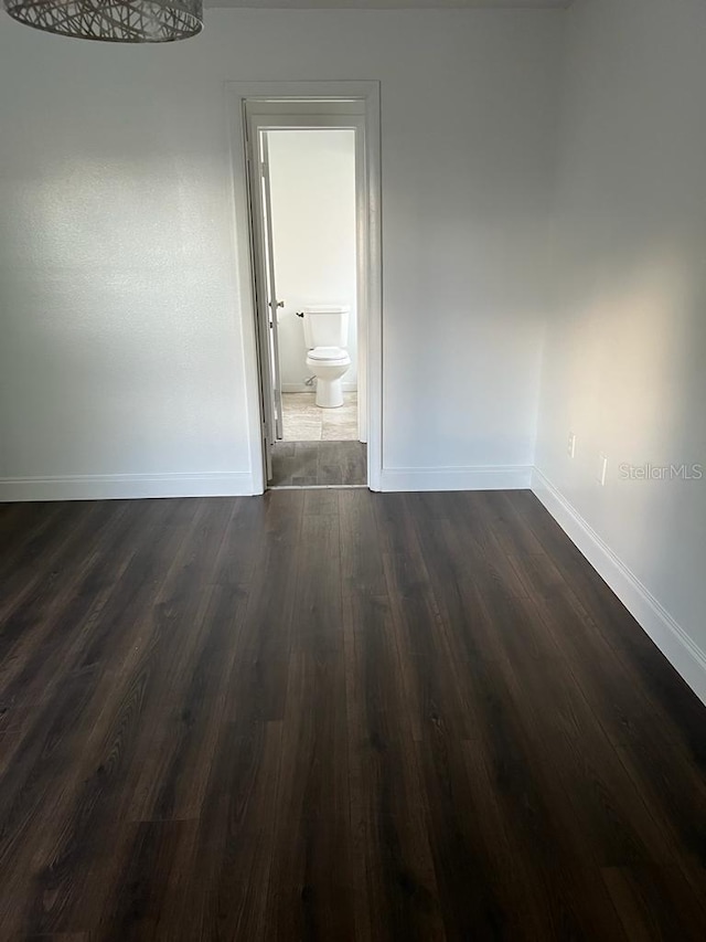 2900 S Semoran Blvd Unit 1, Orlando, FL 32822 - empty room featuring baseboards and dark wood-type flooring