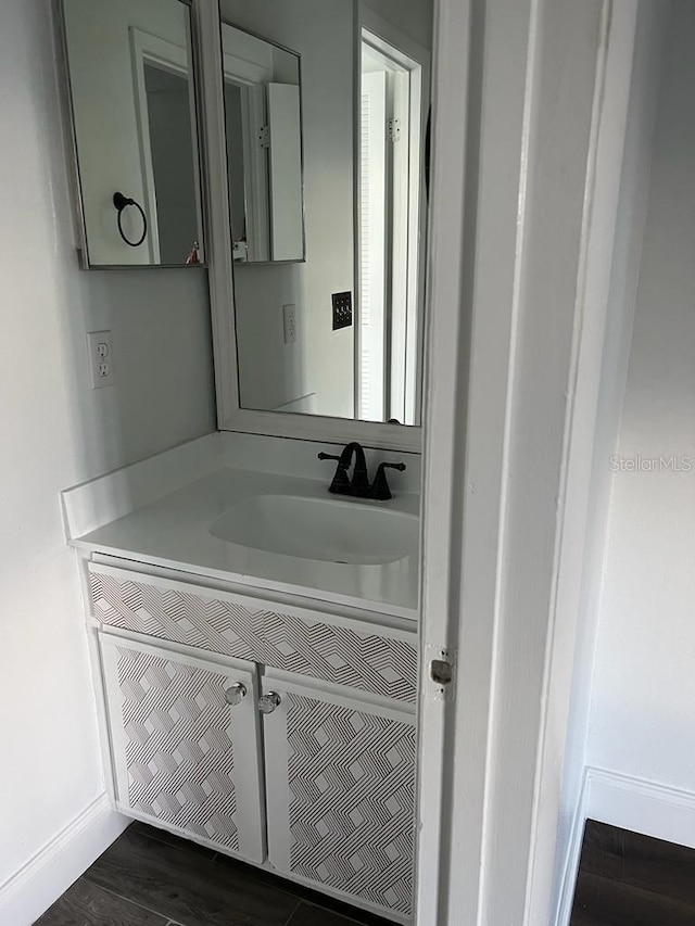 2900 S Semoran Blvd Unit 1, Orlando, FL 32822 - bathroom with vanity, baseboards, and wood finished floors