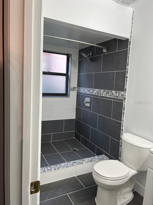2900 S Semoran Blvd Unit 1, Orlando, FL 32822 - bathroom with a shower stall, toilet, and tile patterned floors