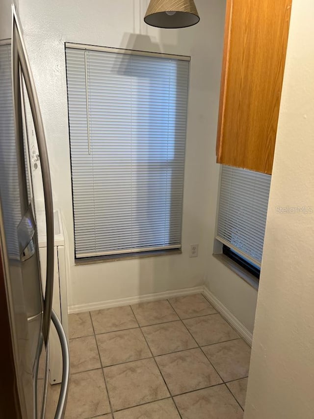 2900 S Semoran Blvd Unit 1, Orlando, FL 32822 - unfurnished dining area with light tile patterned flooring and baseboards
