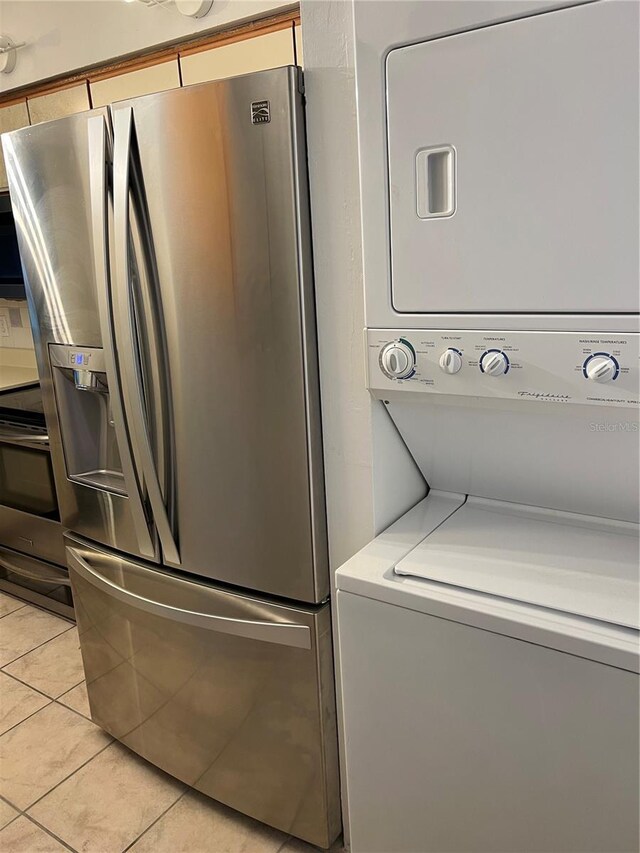 2900 S Semoran Blvd Unit 1, Orlando, FL 32822 - laundry area featuring stacked washer and clothes dryer and light tile patterned floors
