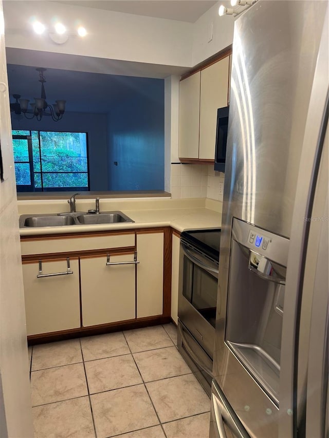 2900 S Semoran Blvd Unit 1, Orlando, FL 32822 - kitchen with appliances with stainless steel finishes, a sink, light countertops, light tile patterned flooring, and backsplash