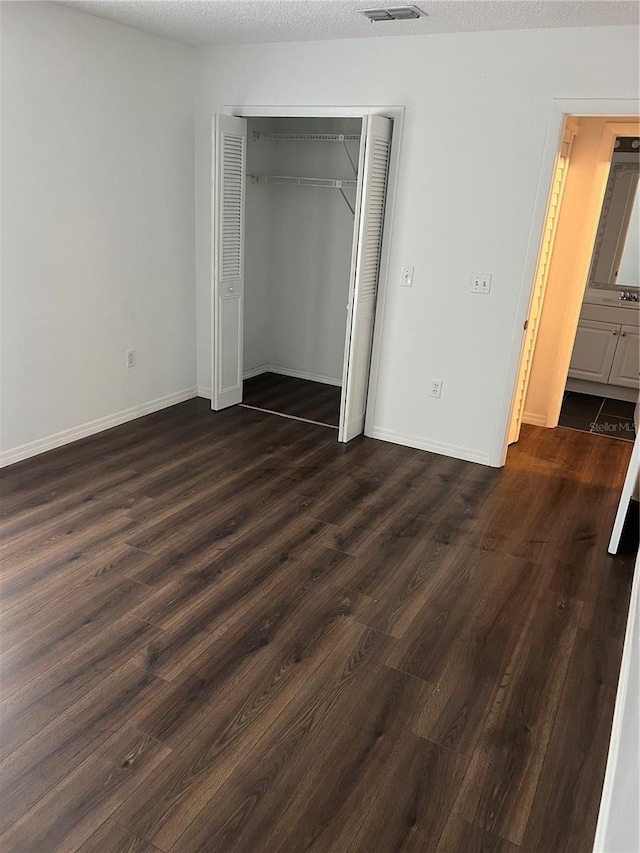 2900 S Semoran Blvd Unit 1, Orlando, FL 32822 - unfurnished bedroom with dark wood-type flooring, a closet, and baseboards