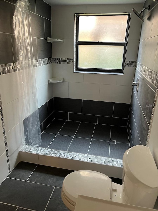 2900 S Semoran Blvd Unit 1, Orlando, FL 32822 - full bathroom with toilet, a stall shower, tile patterned flooring, and tile walls
