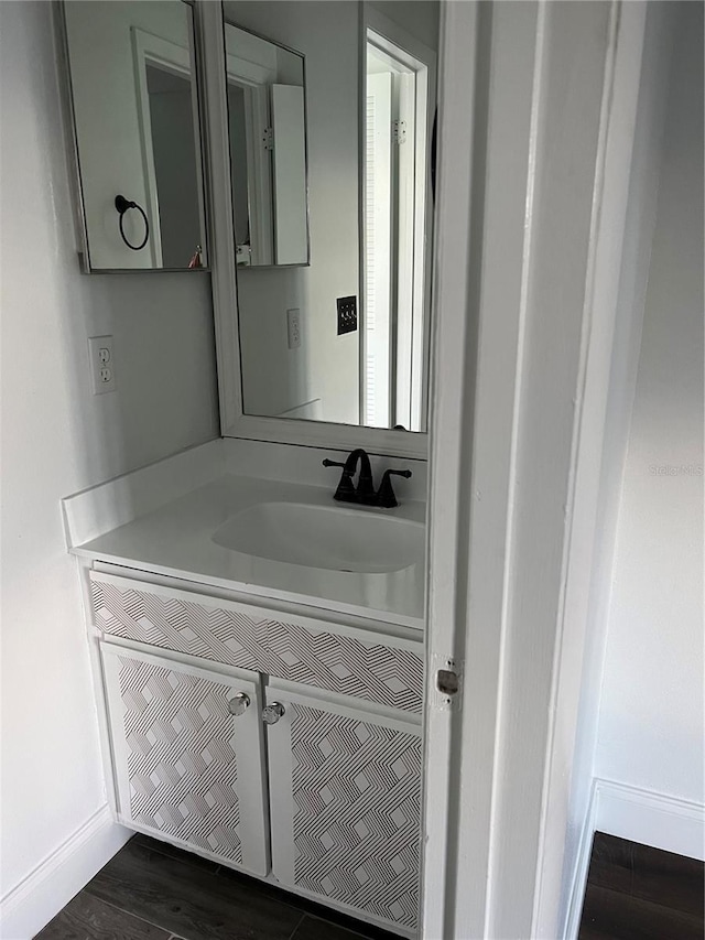 2900 S Semoran Blvd Unit 1, Orlando, FL 32822 - bathroom featuring vanity, baseboards, and wood finished floors