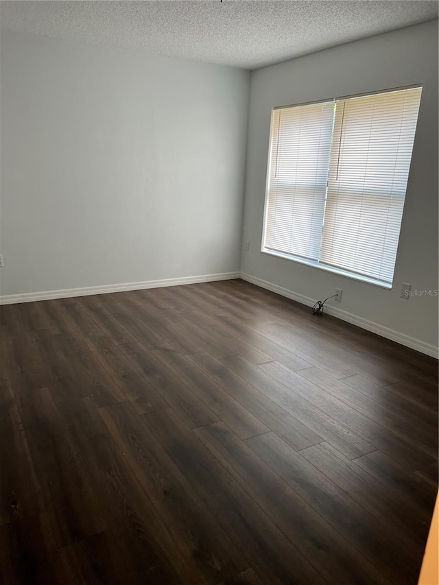 2900 S Semoran Blvd Unit 1, Orlando, FL 32822 - unfurnished room with dark wood-style flooring, a textured ceiling, and baseboards