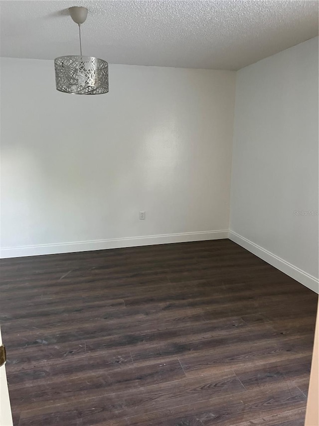 2900 S Semoran Blvd Unit 1, Orlando, FL 32822 - empty room with dark wood-type flooring, baseboards, and a textured ceiling