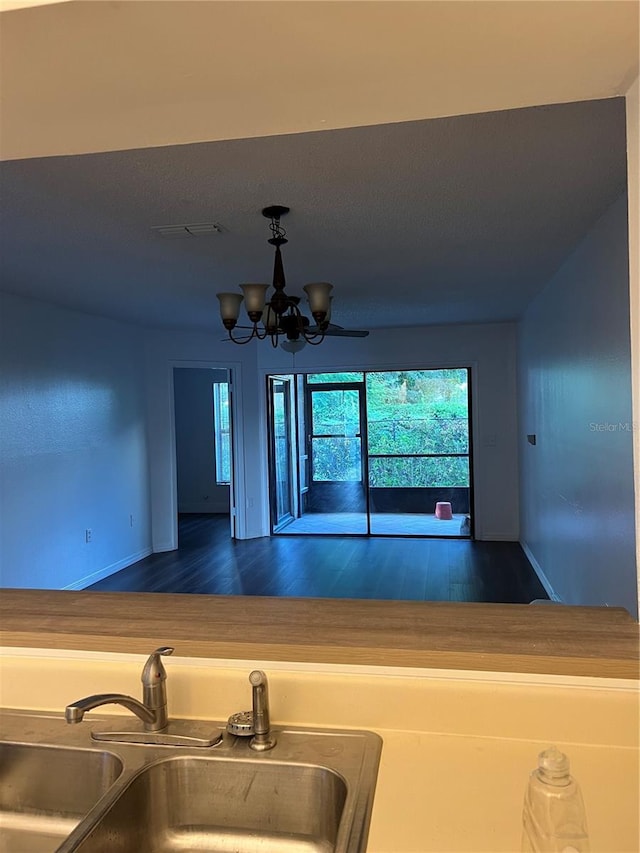 2900 S Semoran Blvd Unit 1, Orlando, FL 32822 - kitchen with a sink, wood finished floors, baseboards, and a chandelier