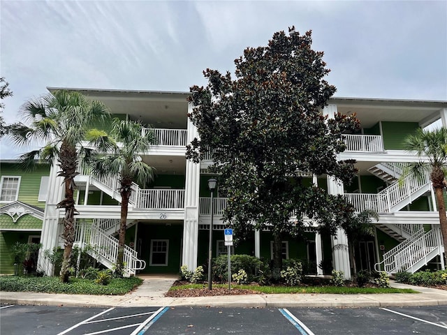 1106 Gran Bahama Blvd Unit 1106, Davenport, FL 33897 - view of building exterior with stairs and uncovered parking
