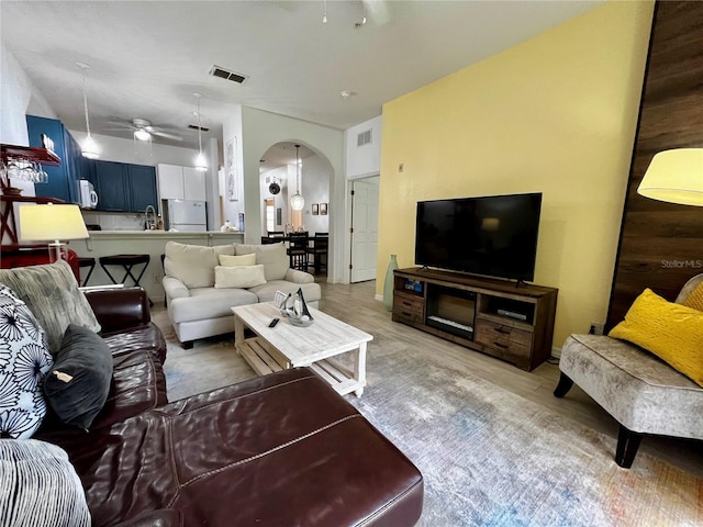 1106 Gran Bahama Blvd Unit 1106, Davenport, FL 33897 - living area with a ceiling fan, arched walkways, and light wood finished floors