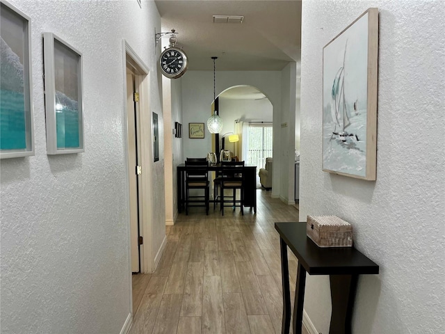 1106 Gran Bahama Blvd Unit 1106, Davenport, FL 33897 - hall featuring a textured wall, arched walkways, and wood finished floors