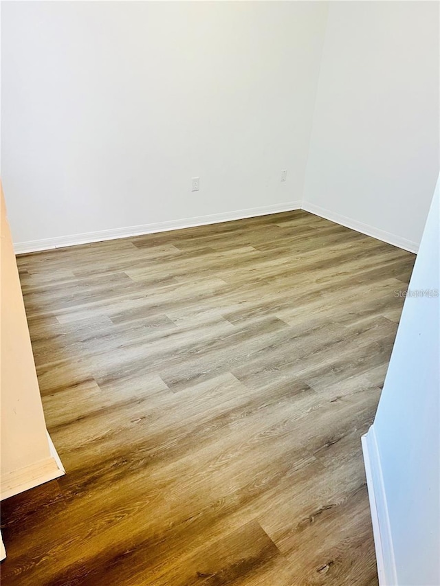 658 Caribbean Dr, Davenport, FL 33897 - spare room featuring wood finished floors and baseboards