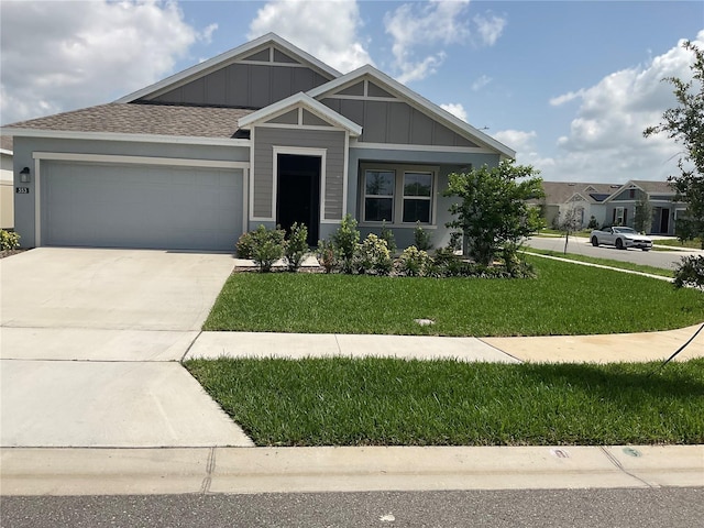 553 SE Turtle, Haines City, FL 33844 - view of front of property with a garage, board and batten siding, a front lawn, and driveway