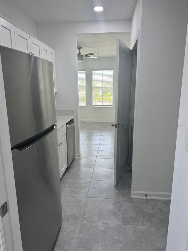 553 SE Turtle, Haines City, FL 33844 - kitchen with stainless steel appliances, white cabinetry, light tile patterned floors, a ceiling fan, and recessed lighting