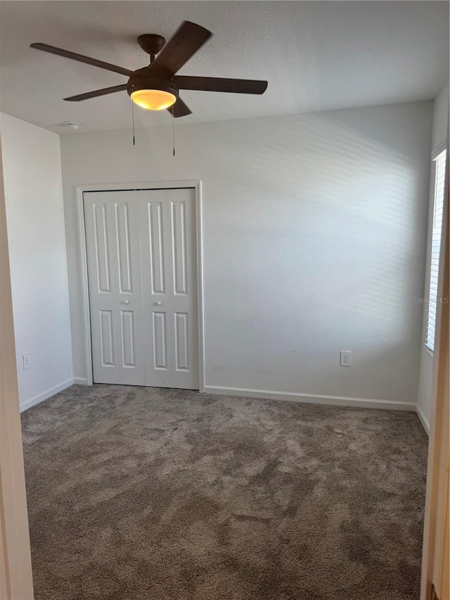 553 SE Turtle, Haines City, FL 33844 - unfurnished bedroom featuring a closet, carpet floors, and a ceiling fan