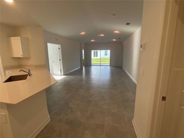 553 SE Turtle, Haines City, FL 33844 - unfurnished living room with recessed lighting and dark tile patterned floors