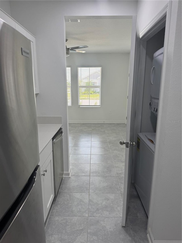 553 SE Turtle, Haines City, FL 33844 - hallway featuring stacked washing machine and dryer and light tile patterned floors