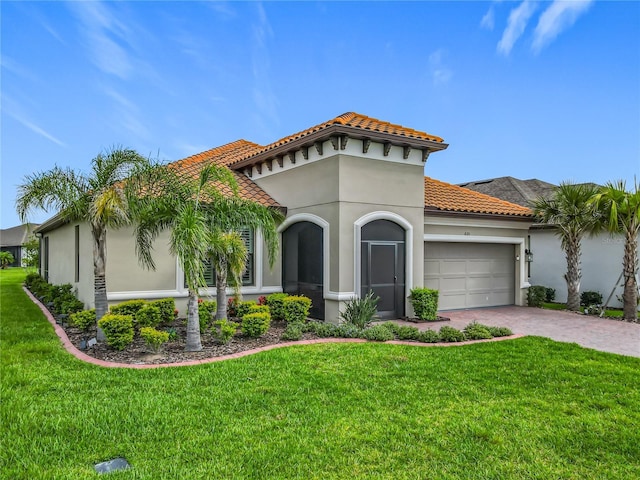 605 San Augusto Dr, Kissimmee, FL 34759 - mediterranean / spanish-style house with a tile roof, a garage, a front lawn, and driveway