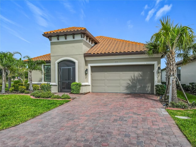 605 San Augusto Dr, Kissimmee, FL 34759 - mediterranean / spanish house featuring a tile roof, stucco siding, decorative driveway, and a garage