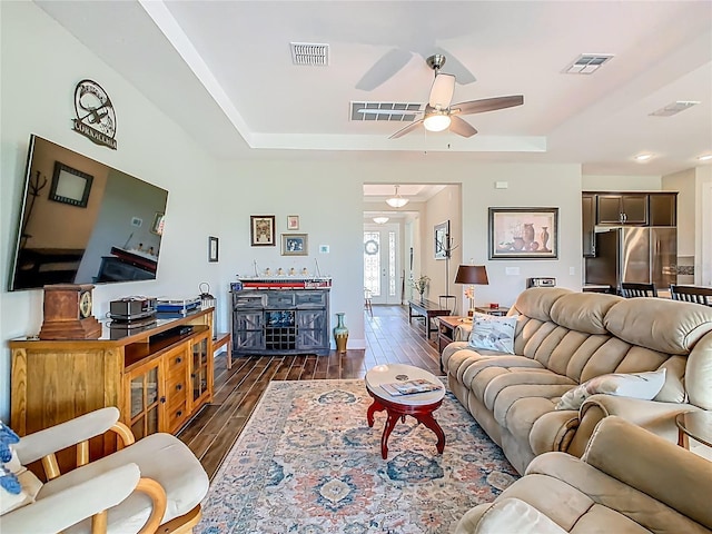 605 San Augusto Dr, Kissimmee, FL 34759 - living room with dark wood finished floors, a tray ceiling, and a ceiling fan