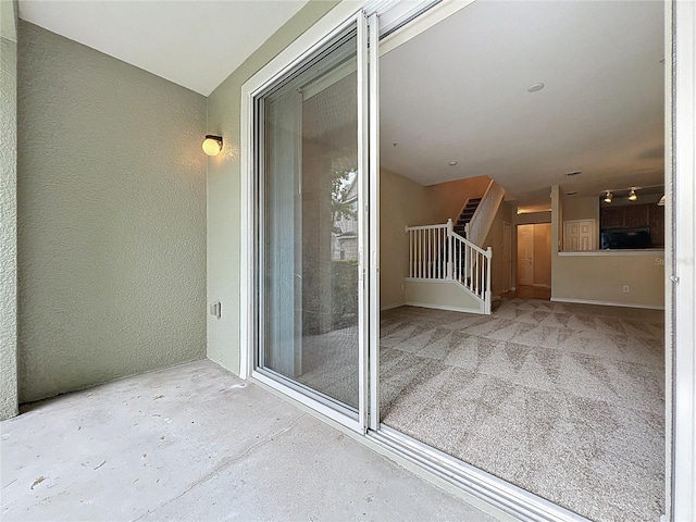 10746 Regent Square Dr Unit 1502, Orlando, FL 32825 - view of exterior entry with a balcony and stucco siding