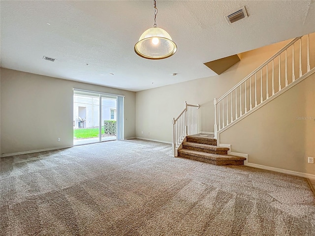 10746 Regent Square Dr Unit 1502, Orlando, FL 32825 - unfurnished living room with carpet flooring, stairs, baseboards, and a textured ceiling