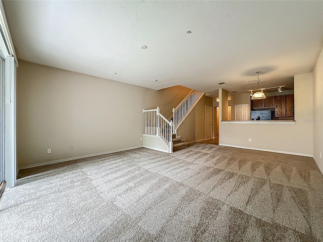 10746 Regent Square Dr Unit 1502, Orlando, FL 32825 - unfurnished living room featuring carpet flooring, stairs, and baseboards