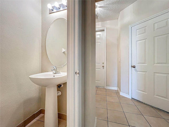 10746 Regent Square Dr Unit 1502, Orlando, FL 32825 - bathroom with tile patterned floors, a textured ceiling, and baseboards
