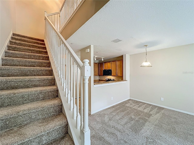 10746 Regent Square Dr Unit 1502, Orlando, FL 32825 - stairway featuring carpet, a textured ceiling, and baseboards