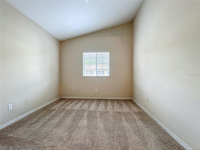 10746 Regent Square Dr Unit 1502, Orlando, FL 32825 - spare room with vaulted ceiling, light carpet, and baseboards