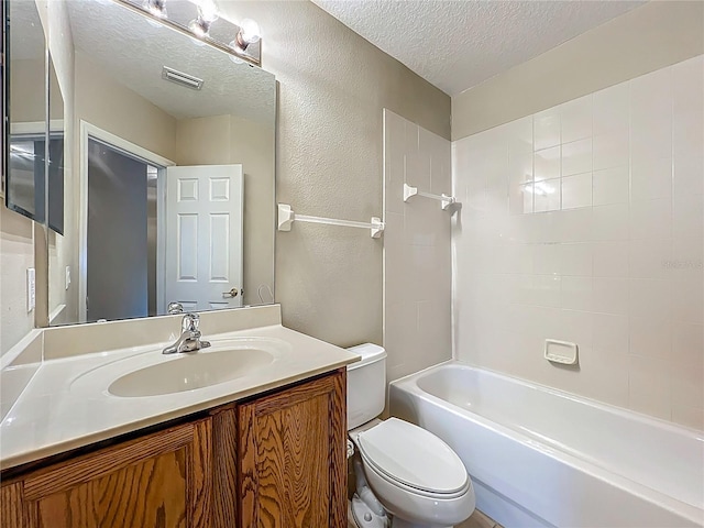 10746 Regent Square Dr Unit 1502, Orlando, FL 32825 - full bath featuring a textured ceiling, toilet, vanity, a textured wall, and bathing tub / shower combination